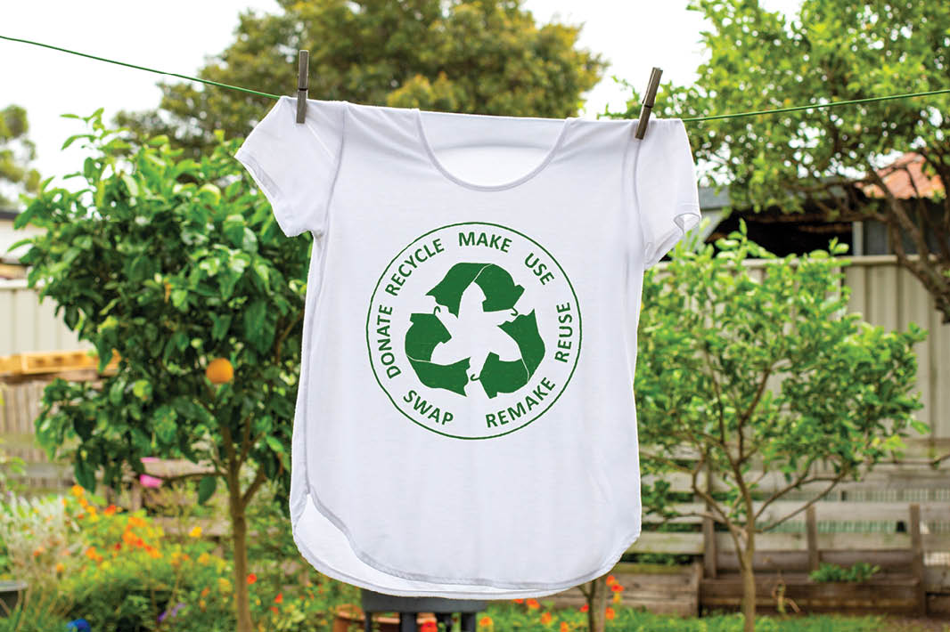 T shirt on washing line with circular economy textiles icon, make, use, reuse, swap, donate, recycle with eco clothes recycle icon sustainable fashion concept