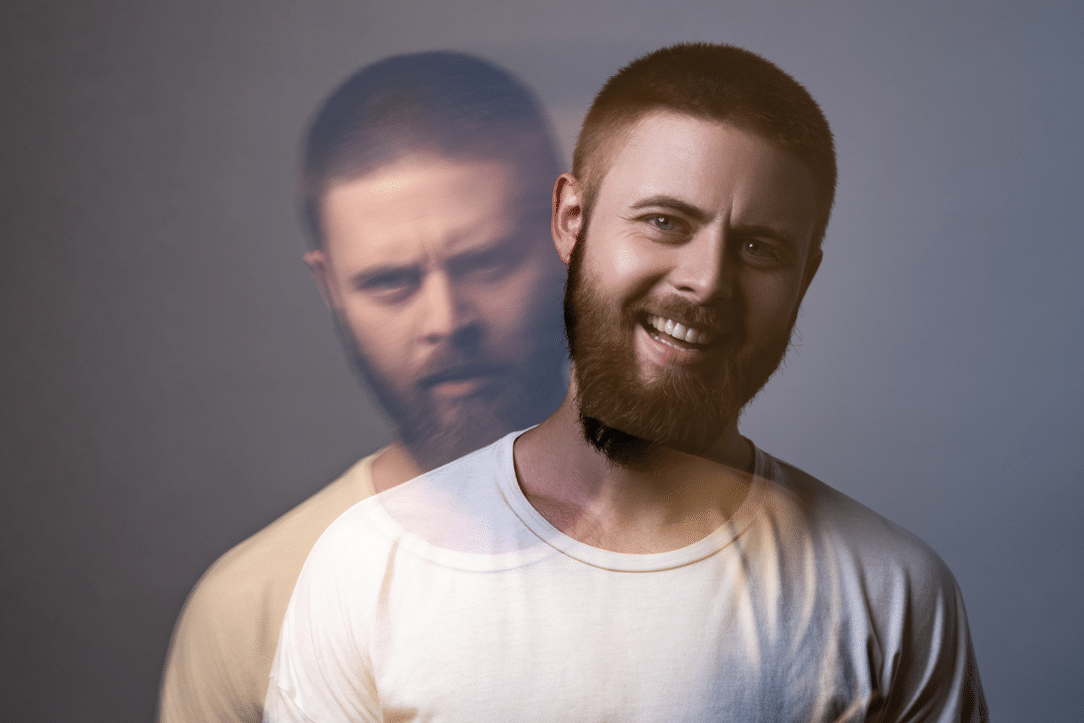 Portrait of two-faced man in calm serious and happy expression. Different emotion inside and outside mood. Internally suffering, dissociative identity disorder. Double exposure. indoor, studio shot
