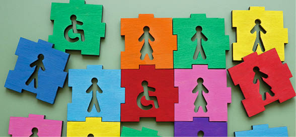 Puzzle pieces with male, female figures and disability sign representing inclusion and diversity.